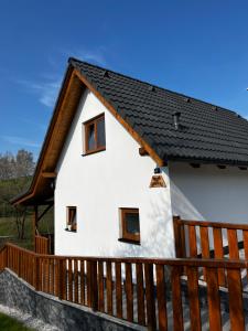 a white house with a black roof at Chata Nechata in Velhartice