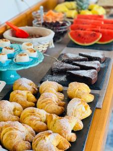 a tray of pastries and other foods on a table at Regina Elena Rooms in Avola
