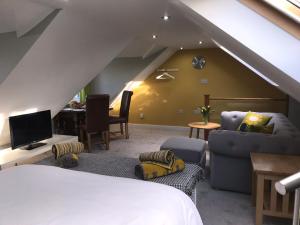 a bedroom with a bed and a living room at Round-y-Corner in Macclesfield