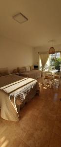 a bedroom with a bed and a couch and a table at Munich Apart cdelu in Concepción del Uruguay