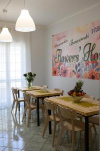 a dining room with wooden tables and chairs at Flowers' House in Castellammare di Stabia