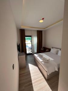 a hotel room with a bed and a window at Life Point Hotel in Çeşme