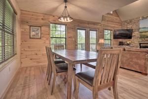a dining room with a wooden table and chairs at Furnished Deck and Grill Rustic Pigeon Forge Cabin in Pigeon Forge