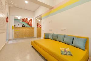 a large yellow bed in a room with a staircase at Locul Midtown-Indiranagar in Bangalore