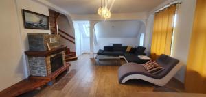 a living room with a couch and a fireplace at Mazurska przystań in Dąbrówno