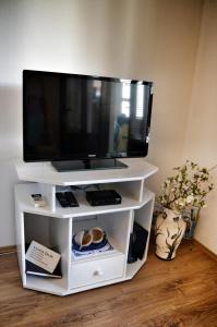 a flat screen tv on a white entertainment center at Apartment Nikolic in Kaštela