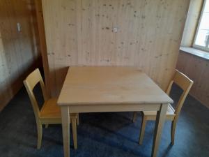 Santa Maria的住宿－Ostello Santa Maria 6541 Santa Maria，一张木桌和两张椅子