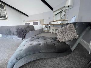 a bedroom with a bed and a large couch at The Whittington and Cat in Hull