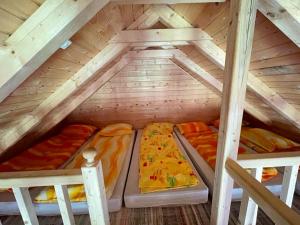 a room with three beds in a attic at Forest Guest House 2 in Sîntimbru-Băi