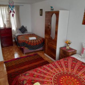 a living room with two beds and a bed sidx sidx sidx at Hostel mágico San Blas in Cusco