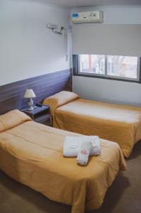 En eller flere senge i et værelse på Rioma Hotel
