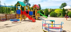 a playground in the sand with a slide at Zajazd Zaścianek in Bargłów Kościelny