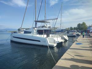 a boat is docked at a dock in the water at CozyLuxuryApartment in Keramoti