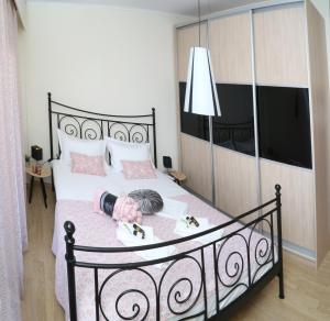 a doll laying on a bed in a bedroom at CozyLuxuryApartment in Keramoti