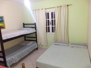 two bunk beds in a room with a window at Arraial do Cabo in Arraial do Cabo