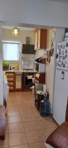 a kitchen with a white refrigerator and a stove at Triplex house, near center and sea in Datca