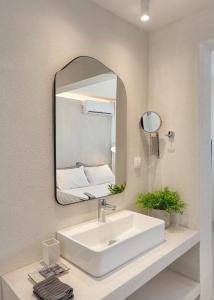 a bathroom with a white sink and a mirror at Beach Bird (Sandpiper) 140m2 Chalkidiki Greece in Kalives Poligirou