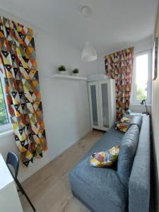 a living room with a couch and a window at Pokoje Gdańsk Oliwa - Mściwoja II 50, do morza 1,9km, 750m SKM Oliwa, 1,1km Park Oliwski in Gdańsk