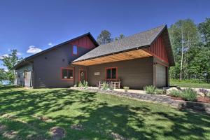 a barn style house with a gambrel roof at Modern Lakeside Chalet on Crow Wing Chain with Dock! in Nevis