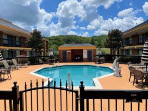 a swimming pool with chairs and tables in a courtyard at Best Western - Fayetteville in Fayetteville