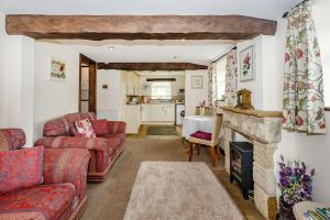 a living room with a couch and a fireplace at Fir Tree Stables in Summer Bridge