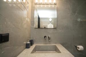 a bathroom with a sink and a mirror at Luxury Premium Suite #1 in Chalkida