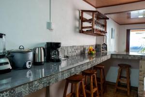 a kitchen with a counter with bar stools at Tony's House in Fortuna