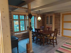 a dining room with a table and chairs at Villmarksgård tømmerstue in Hattfjelldal