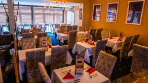 a dining room with tables and chairs in a room at Dutchman Hotel in Blackpool