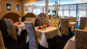 a dining room with tables and chairs in a room at Dutchman Hotel in Blackpool