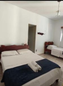 1 dormitorio con 1 cama grande con manta azul en POUSADA CARVALHO en Pirenópolis