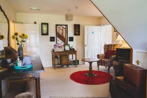a living room with a couch and a table at Higher Farm in Malpas