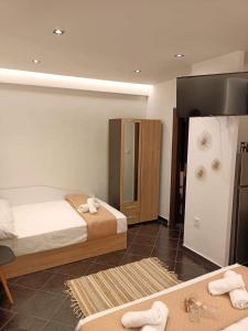 a hotel room with two beds and a mirror at ALEXANDER APARTMENT'S in Kallithea Halkidikis