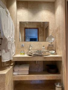 W łazience znajduje się umywalka i lustro. w obiekcie Suite au Bord du Rhône we Vienne