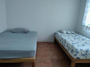 a small bedroom with a bed and a pillow at Big House Op in Barra de la Cruz