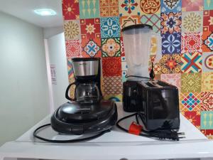 a blender and a toaster sitting on top of a counter at Lindo Estúdio vista mar com cama king in João Pessoa +7 photos