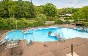 a large swimming pool with a slide in a park at Dancamps Trelde Naes in Fredericia