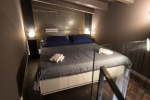 a bedroom with a bed with two towels on it at il sacrato di casa loreto in Catania
