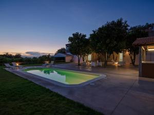 a swimming pool in a backyard at night at Quinta da Teimosa in Monção