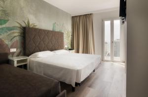 Postel nebo postele na pokoji v ubytování Hotel President