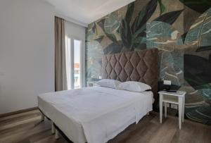 Postel nebo postele na pokoji v ubytování Hotel President
