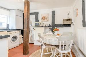 a kitchen and dining room with a table and chairs at Fern Hall Cottage in Upper Welson