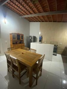 a wooden table and chairs in a kitchen at Casa Mar é Vida in Prea