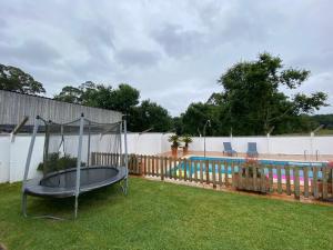 a trampoline in a yard next to a pool at Villa Poexa in Rosal +8 photos