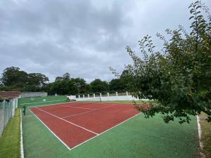 a tennis court with a tennis court at Villa Poexa in Rosal