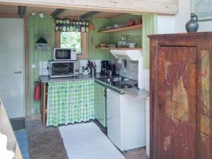 a kitchen with a stove and a microwave at 5 person holiday home in FLODA in Floda