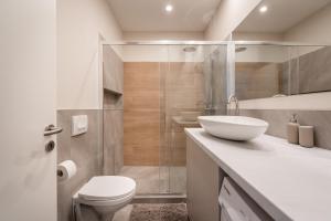 a bathroom with a toilet and a sink and a shower at A13- Boutique Apartments, Best Location, by BQA in Budapest