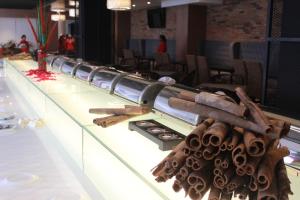 a buffet line with wooden logs on top of it at Hotel Excelsior Ipoh in Ipoh