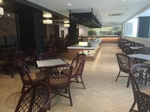 a dining room with tables and chairs and a restaurant at Hotel Excelsior Ipoh in Ipoh +32 photos