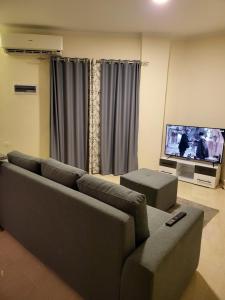 a living room with a couch and a flat screen tv at Luxury Aqua Tropical Resort Next To Al Gouna 4 0 1 in Hurghada